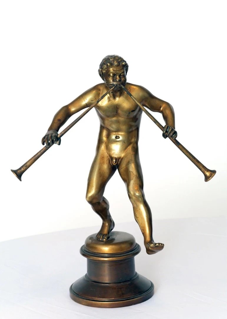 Dancing faun with a double flute